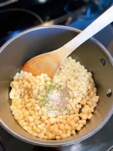 Adding salt, pepper, parsley to corn